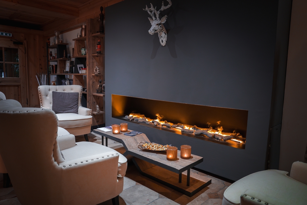 A cosy loungeroom focusing on a long gas fireplace.