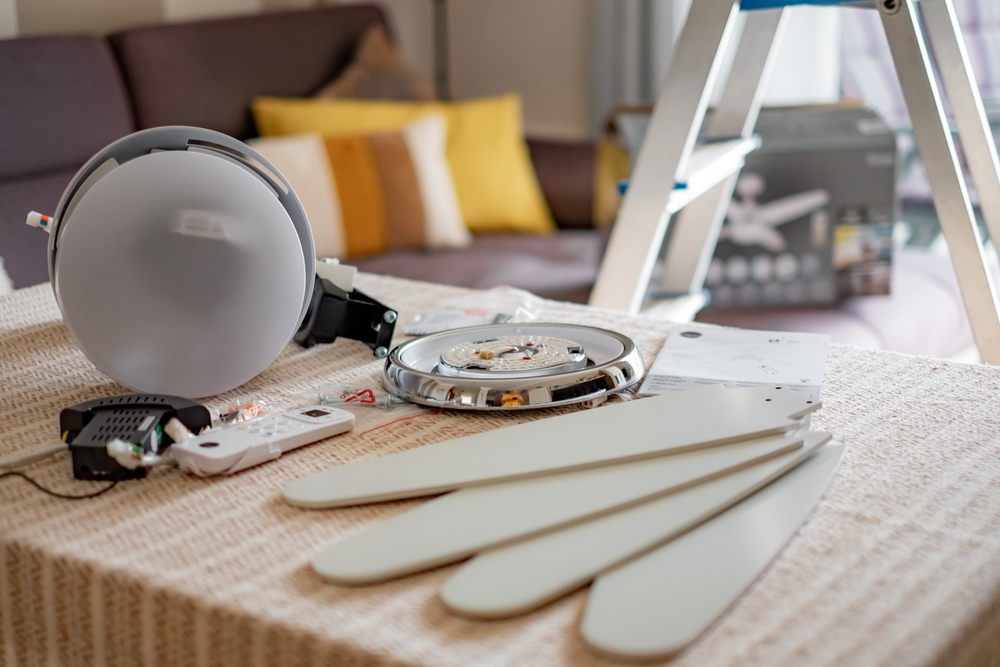A ceiling fan and its accessories waiting to be installed. 