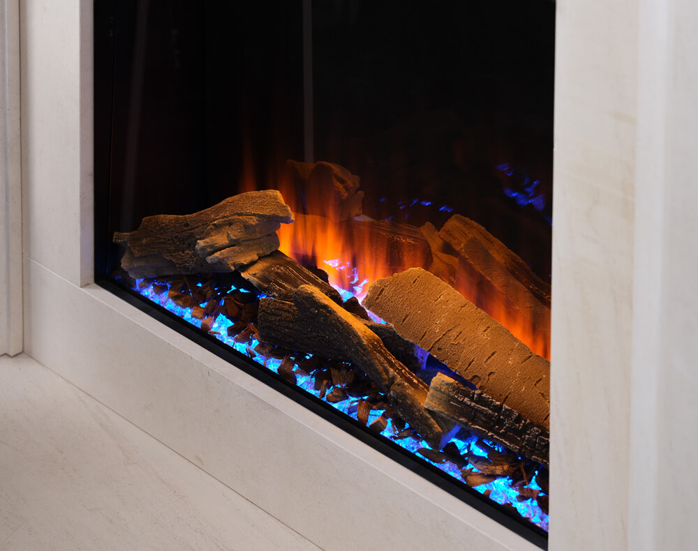 A close-up view of an inbuilt electric fireplace featuring realistic logs and a modern blue LED ember bed