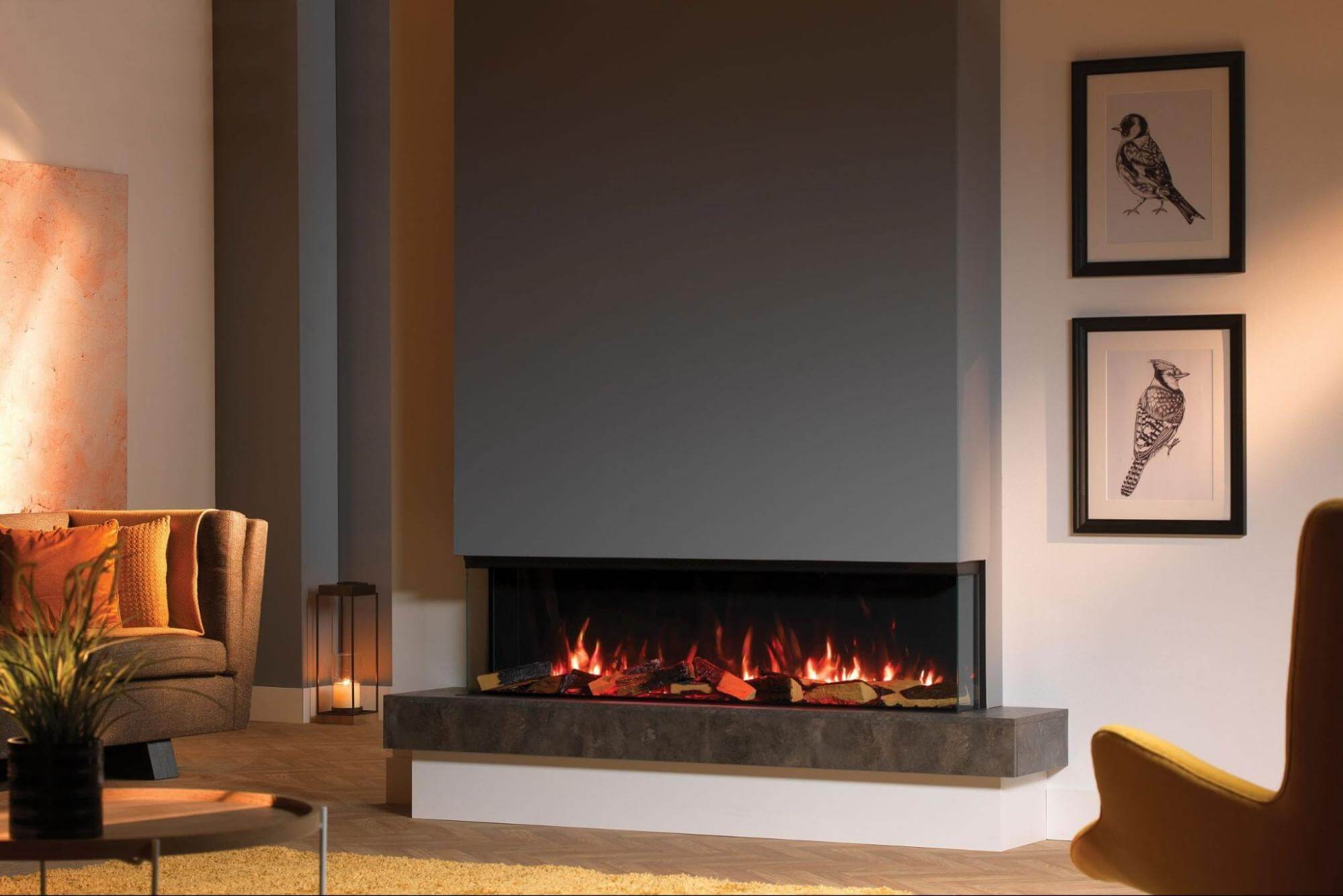 A sleek, wide-profile inbuilt electric fireplace installed into a minimalist grey feature wall in a contemporary Sydney apartment