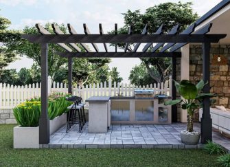A small outdoor kitchen with a built in BBQ on a patio.